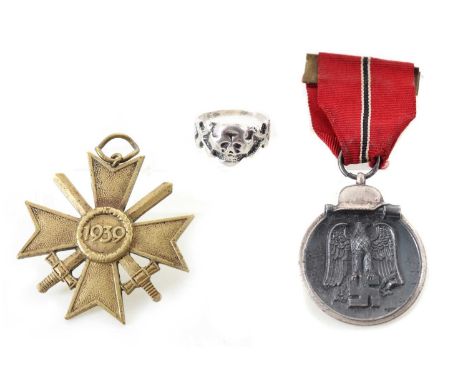 TWO GERMAN THIRD REICH TYPE MEDALS, ALONG WITH A TOTENKOPF RING the medals comprising the Winter Campaign medal and the War M