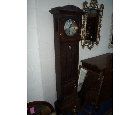 AN OAK LONGCASE CLOCK WITH BEVELLED GLASS DOOR (key and pendulum)