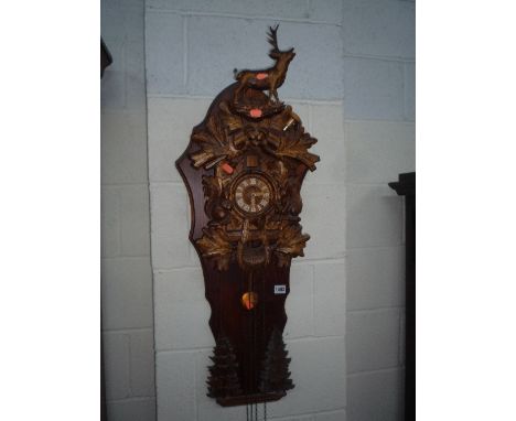 A BLACK FOREST STYLE CUCKOO CLOCK (pendulum and two weights)