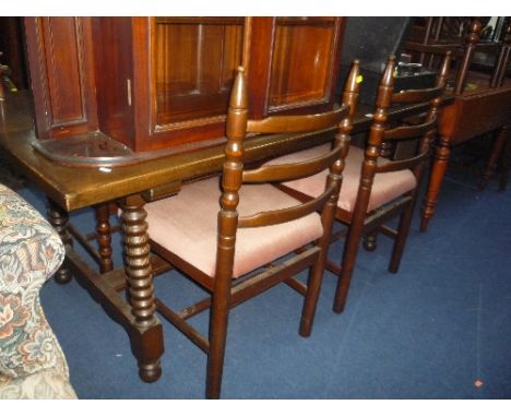 AN OAK DINING TABLE AND SIX LADDER BACK CHAIRS (7)