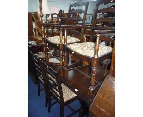 AN OAK DINING TABLE AND SIX LADDER BACK CHAIRS, including two carvers (7)