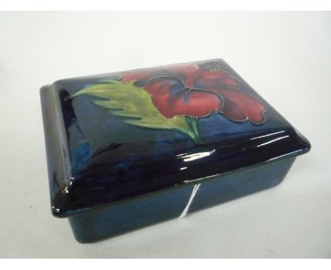 A MOORCROFT POTTERY RECTAGNULAR TRINKET BOX, 'Hibiscus' pattern, paper label and impressed marks to base, approximate length 