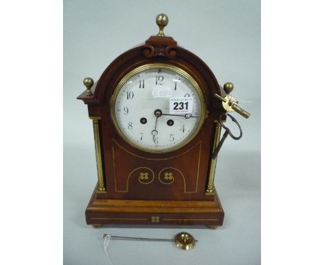 AN INLAID EDWARDIAN BRACKET CLOCK, with French movement, circular enamel dial with Arabic numerals, approximate height 34cm (