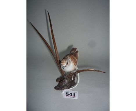AN ALBANY WORCESTER PORCELAIN BIRD 'DUNNOCK', perched on metal branches/reeds