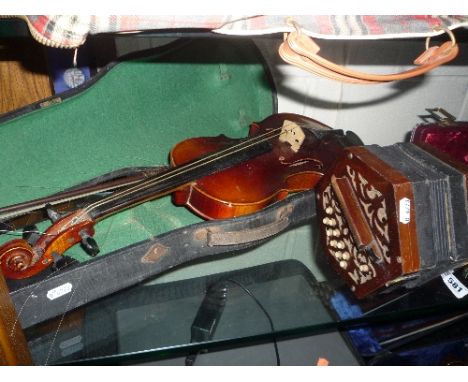 A CASED VIOLIN, Stradivarius copy (sd), together with a German squeeze box, (ten buttons either side) (2)