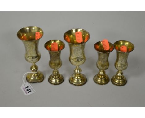 FIVE SILVER STEMMED FLARED RIM CUPS, with engraved decoration , approximately 10cm and 12.5cm high, marks rubbed, three small