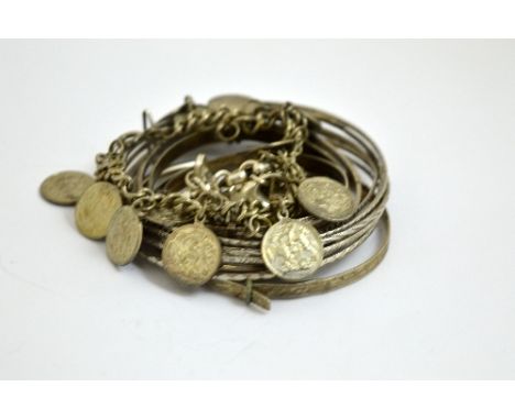 A COLLECTION OF BRACELETS, to include charm, bangle and torque bracelets (8)