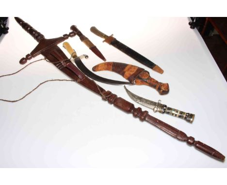 Collection of five Eastern daggers, and a horn handled dagger (6).