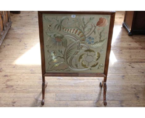 Walnut framed glazed needlework panel firescreen, 87.5cm by 62.5cm.