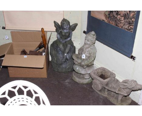 Three garden ornaments and collection of tools.