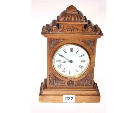Late Victorian carved walnut cased mantel clock, 24cm.