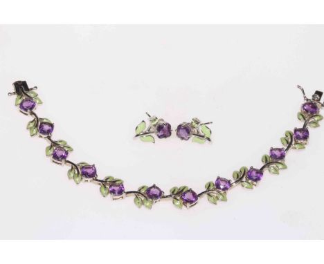 Silver bracelet and earrings with amethyst coloured stones and green enamel flowers.