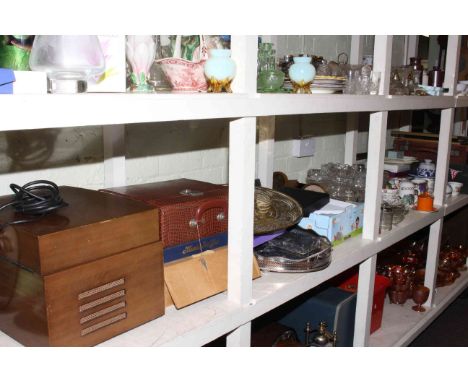 Large shelf collection of linens, collectors plates, glass, ceramics, metalwares, LP records, Pye Gramophone, wood wares, mir