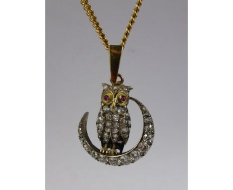An 18 ct Yellow Gold, Silver, Diamond and Ruby Owl Pendant. The owl having ruby eyes and resting on a crescent moon, on 9 ct 