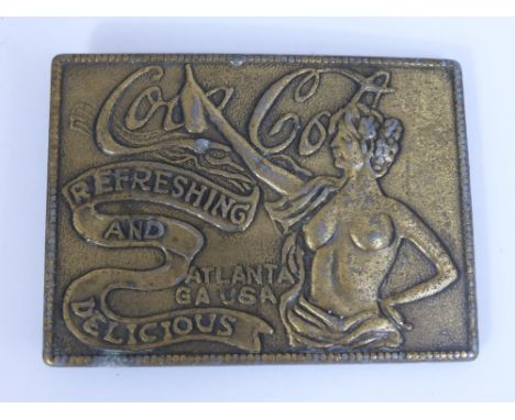 A Vintage American Metal Coca Cola Belt Buckle. The buckle depicting a naked lady with arm outstretched reading "Refreshing a