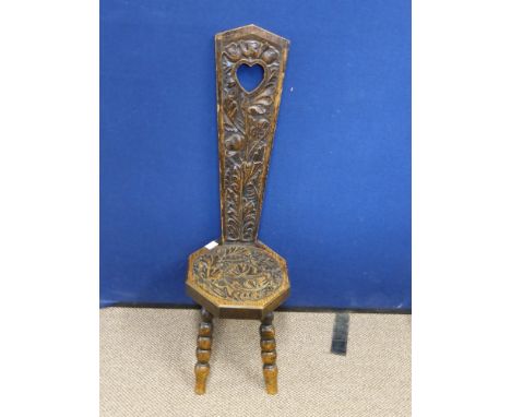 A Vintage Oak Stick Chair on bobbin legs and having carved floral back and seat.