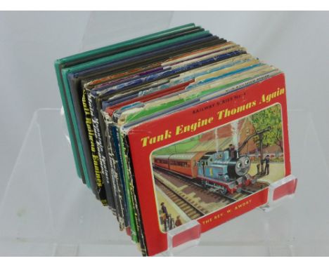 Twelve Vintage Thomas the Tank Engine Books, some with the original covers.