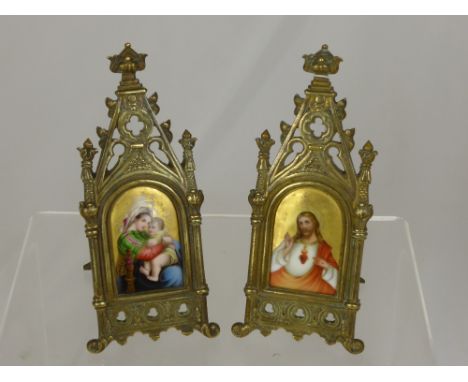 A Pair of 19th Century Gilt Brass Framed Icons, the brass easel frames of ecclesiastical composition, hand painted portrait m