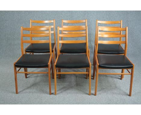 A set of six mid century vintage dining chairs in light beech and faux leather seats. 