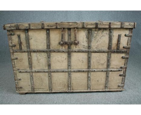 A large 19th century Eastern coffer or travelling trunk, metal bound and with twin carrying handles. H.78 W.125 D.74cm. 