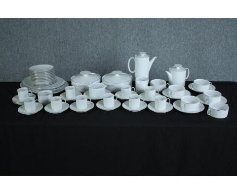 A white china coffee and tee set made by Thon, Germany. Includes coffee and tea pots, cup and saucers, sugar bowls and side p