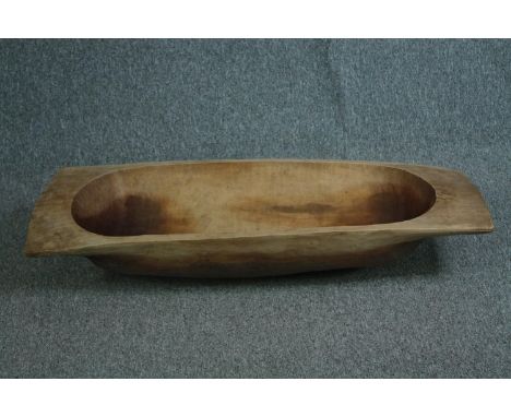 A large carved wooden dough trough. H.10 W.110 D.42 cm. 