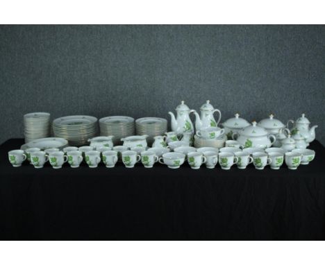 A large Konigl Pr Tettau tea set made up of two teapots, a coffee pot, sugar bowls, creamers, side plates and cup and saucers