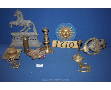 A quantity of brass and metal including a door knocker, a horse doorstop, an old inkwell, horse brass, etc