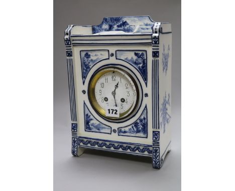 An Edwardian blue and white pottery mantel clock, with dial signed J.W. Benson, 29cm