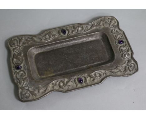 An early 20th century Arts & Crafts repousse white metal and cabochon amethyst set rectangular stand, 22.1cm.