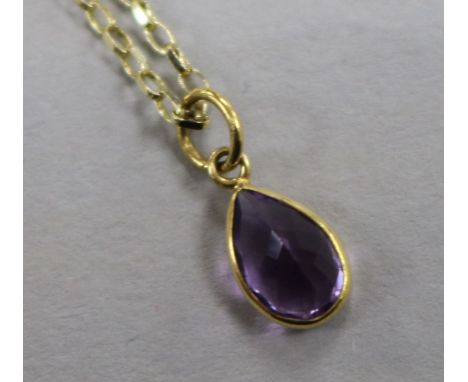 A 9ct gold and amethyst pendant, on a 9ct gold chain, pendant 10mm.
