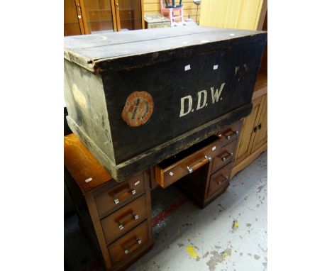 A vintage painted pine cabin trunk bearing old passenger-line labels together with a vintage desk with a bank of seven drawer