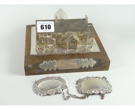 A mounted silver model of Long Oaks Cottage, Penmaen, Swansea (an historic house) on a wooden stand with mounted title label,