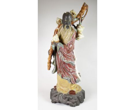 A Lladro pottery model of a Chinese scholar with pomegranates on a naturalistic base, 52cms high Condition reports provided o