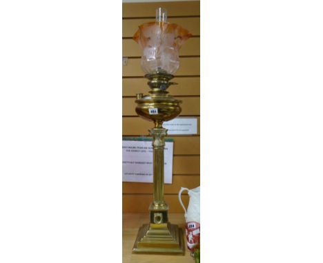 A Thermidor Belge brass architectural antique oil lamp on a stepped base with Romanesque support and having a rose tinted flo