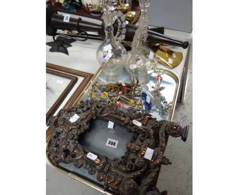 A pair of metallic cherubic easel portrait frames, pair of painted glass decanters and sundry metal items including knife res