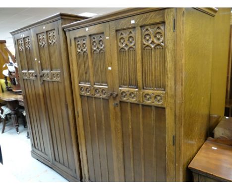 A pair of matching carved panelled wardrobes and a matching dressing table with three centre drawers and wide mirror Conditio