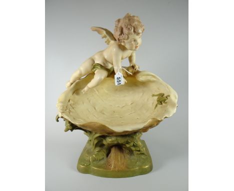 An imposing Royal Dux pottery model of a cherub gazing at a frog inside a clam over a naturalistic base, 37cms high Condition