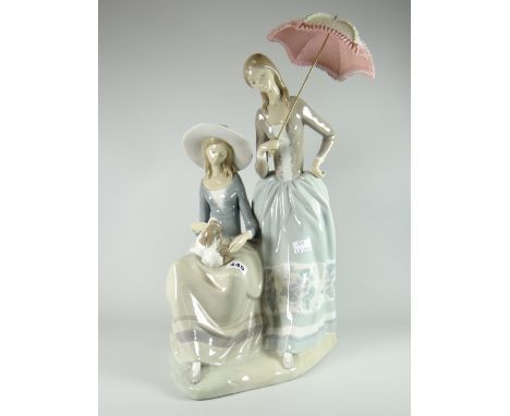 A large Lladro pottery model of two ladies - one seated with puppy, the other standing with parasol, 44cms high Condition rep