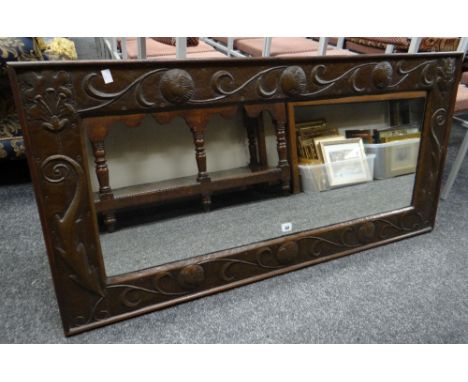 Manner of John Pearson Arts & Crafts copper and wood rectangular wall mirror decorated with bird, scroll and floral motifs, 1