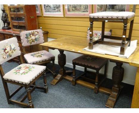 A vintage oak refectory-type breakfast table with floor level stretcher, 136cms long and four floral tapestry covered chairs 