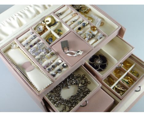 A modern light pink leather covered jewellery box with drawers containing a good assortment of modern jewellery in each compa