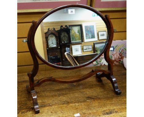 An early twentieth century mahogany oval toilet mirror on stand Condition reports provided on request by email for this aucti