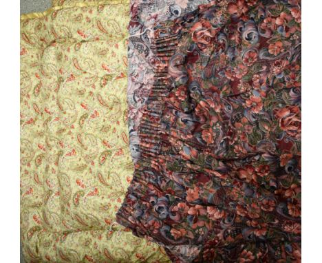 A vintage paisley eiderdown; floral pattern curtains and pelmet