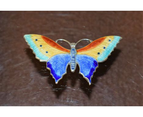 An Art Nouveau style white metal and enamel butterfly brooch