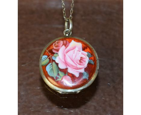 A white metal and enamel locket on chain, the enamel decorated with a rose