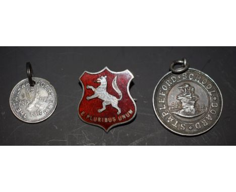 A hallmarked silver and enamel badge; a Stapleford School Board silver fob; Tail Waggers Club 'Help My Pals' medallion (3)