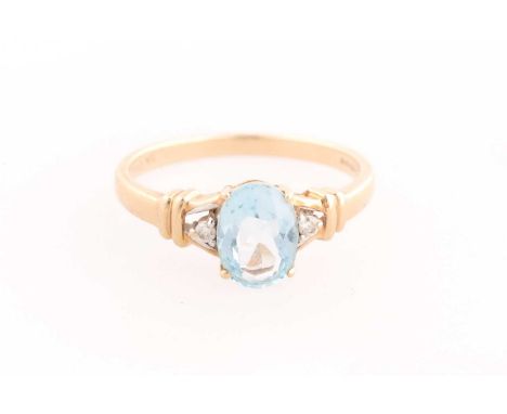 A 9ct yellow gold, diamond, and blue topaz ring, set with a mixed oval-cut topaz, measuring approximately 8 x 6 mm, size N, 2