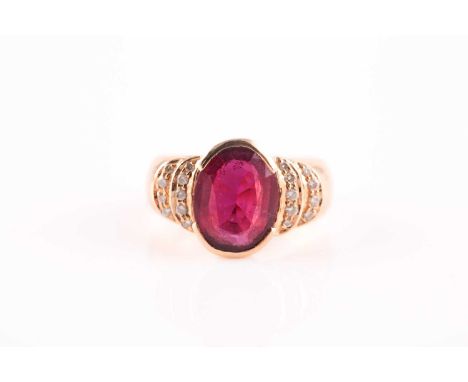 A ruby and diamond half hoop ring, the central oval cut ruby in partial rub-over mount, with crescent shaped diamond set shou