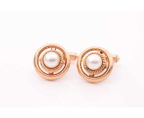 A pair of yellow metal and pearl cufflinks, of round design, centred with a cultured white pearl within a rope-twist border a